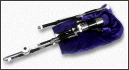 Electronic woodwind controller resembling bagpipes, resting on a cloth surface.